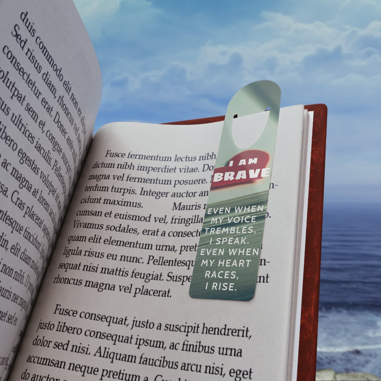 Book with a bookmark featuring the text 'I am brave' against a scenic background.