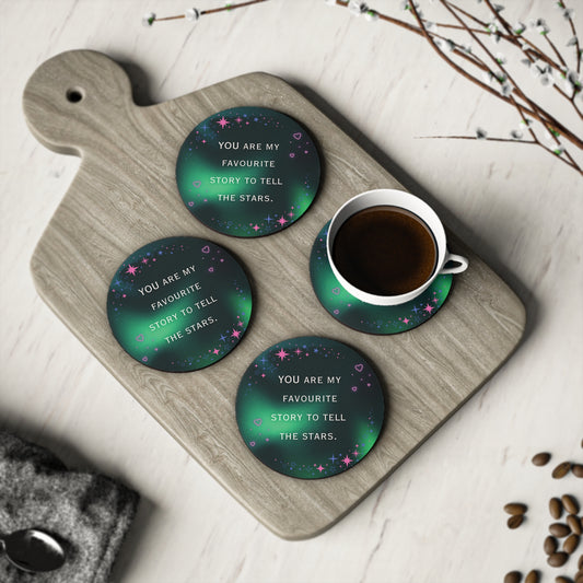 Green coasters with motivational text on a wooden cutting board with a cup of coffee.