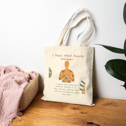 Tote bag with a design and text on a wooden surface with a white wall and plant in the background