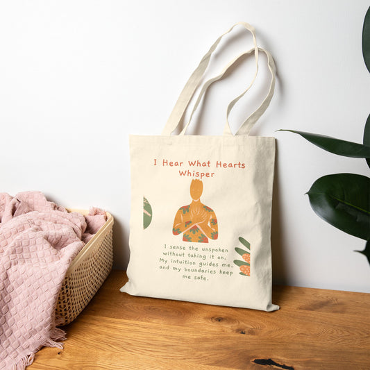 Tote bag with a design and text on a wooden surface with a white wall and plant in the background
