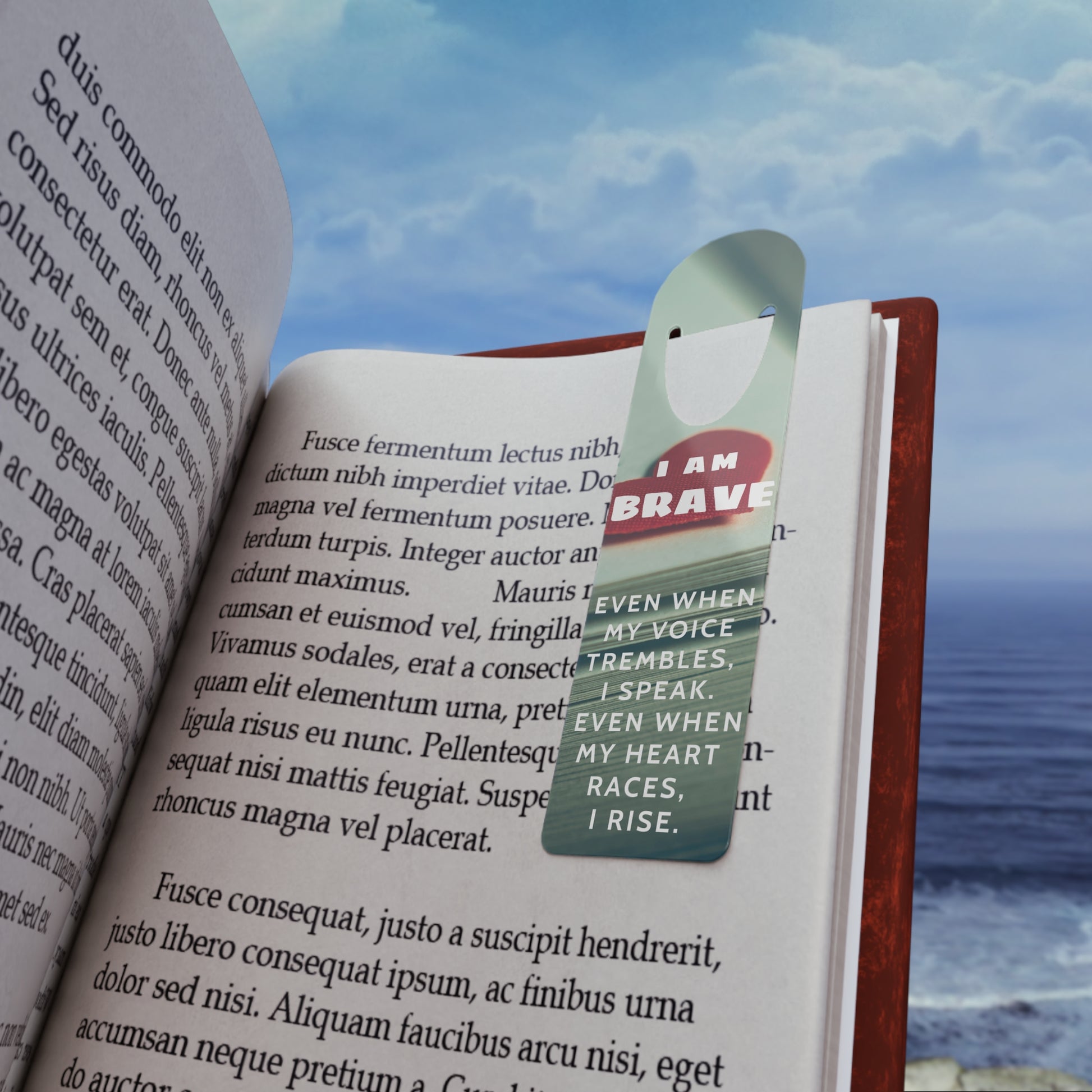 Book with a bookmark featuring the text 'I am brave' against a scenic background.