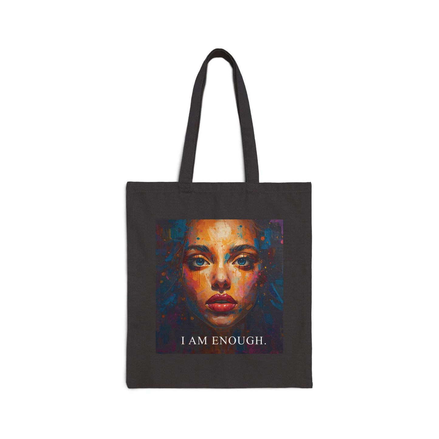Black tote bag with a colorful face design and 'I AM ENOUGH' text on a white background