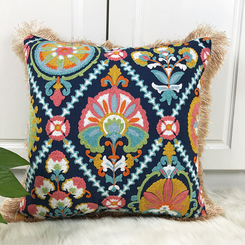 Decorative pillow with colorful geometric pattern on a white surface