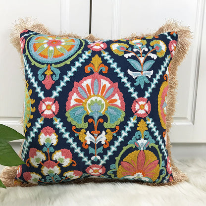 Decorative pillow with colorful geometric pattern on a white surface