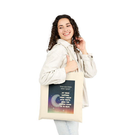 Woman holding a tote bag with a colorful design and text. Even Stars Listen When I Speak Cotton Canvas Tote Bag – Eco-Friendly Motivational Gift for Women, Reusable Shopping Bag with Inspirational Quote