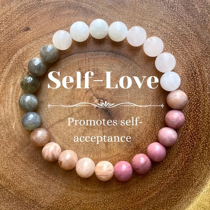 Beaded bracelet with 'Self-Love' and 'Promotes self-acceptance' text on a wooden background