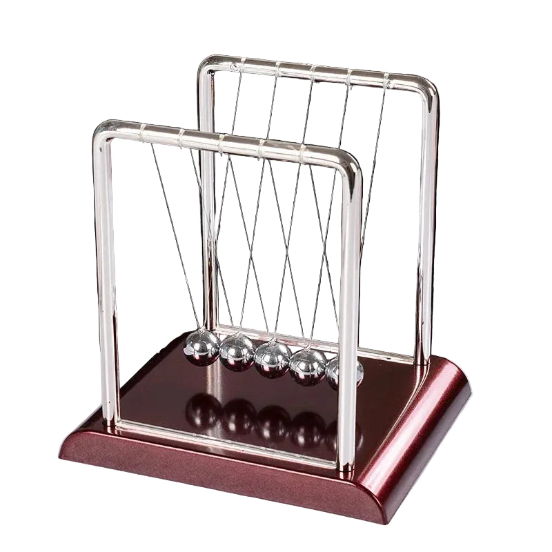 Newton's cradle on a white surface with a black background