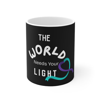 Black mug with 'The World Needs Your Light' text and a heart symbol on a white background